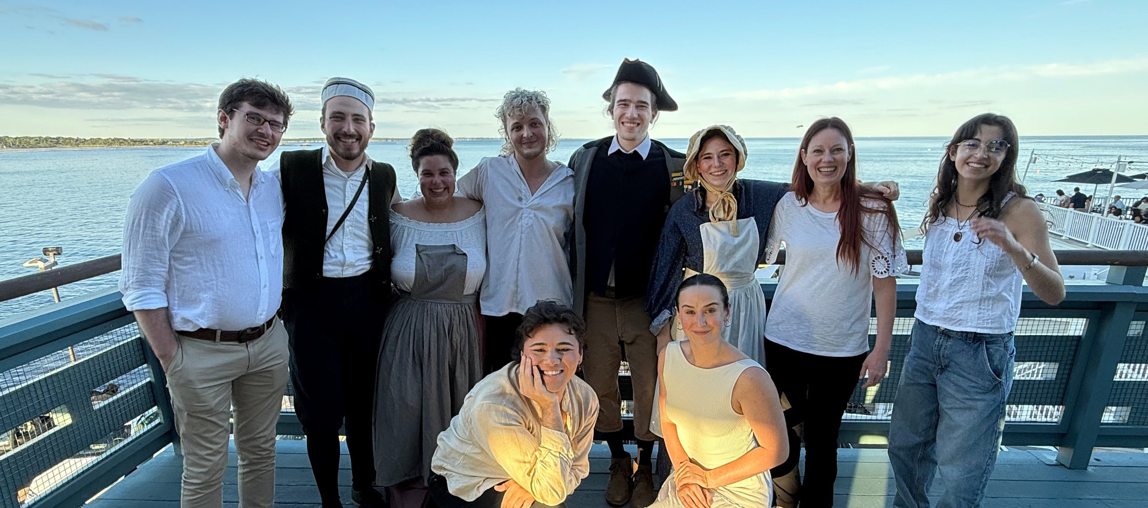 Cast and crew of Sea Fever  posing on a deck of Narragansett Towers, RI  with water and sky in the background
